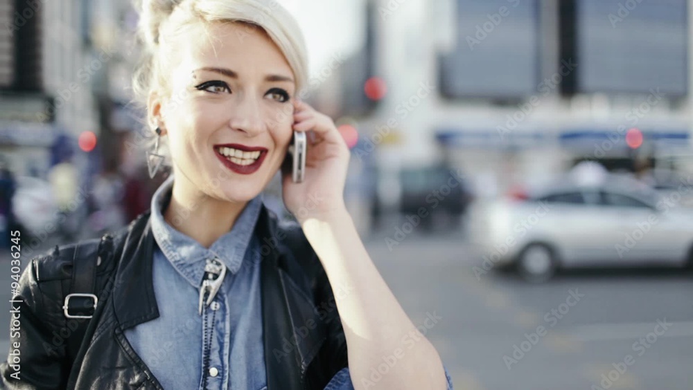 punk style young blond woman talking with smart phone outdoors punk style young blond woman talking with smart phone outdoors