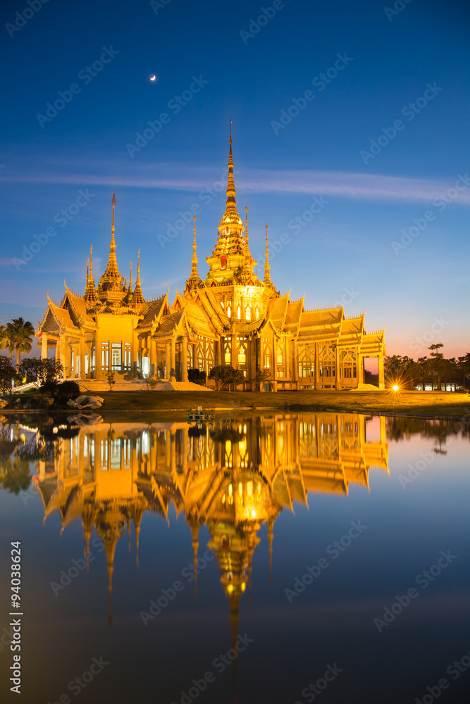 The beautiful golden buddhist temple in night time at Nakhon Ratchasima Thailand
