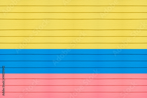 colombia flag on horizontal wood background.