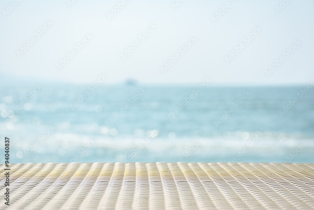 White woven bamboo table with beautiful sea in background