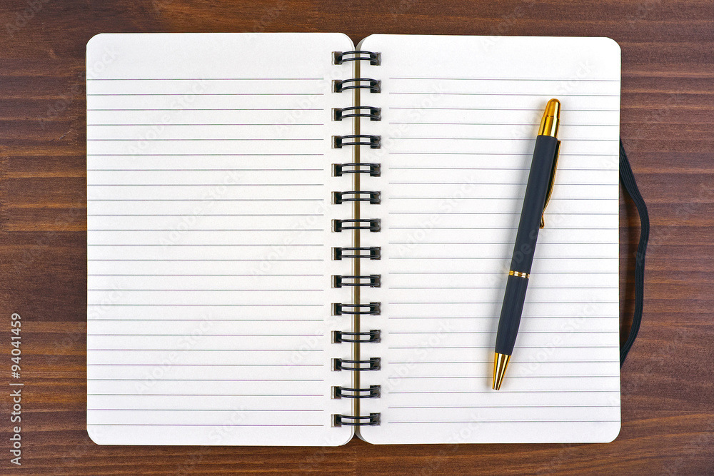 blank open notebook and pen close-up on wood background blank open notebook and pen close-up on wood background