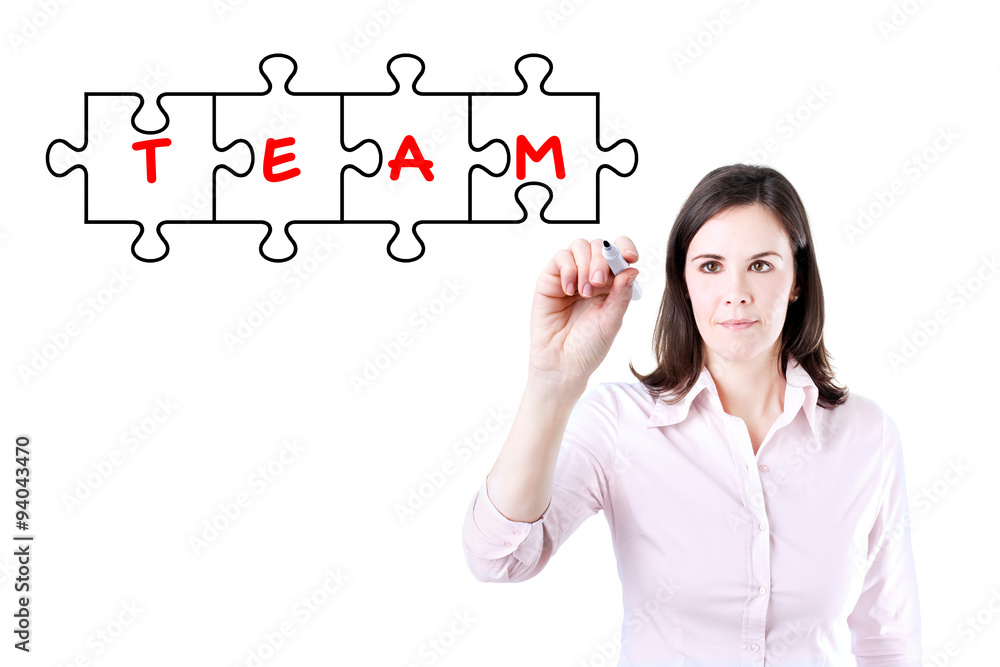 Businesswoman drawing a Teamwork Puzzle Concept on the virtual screen. Businesswoman drawing a Teamwork Puzzle Concept on the virtual screen.