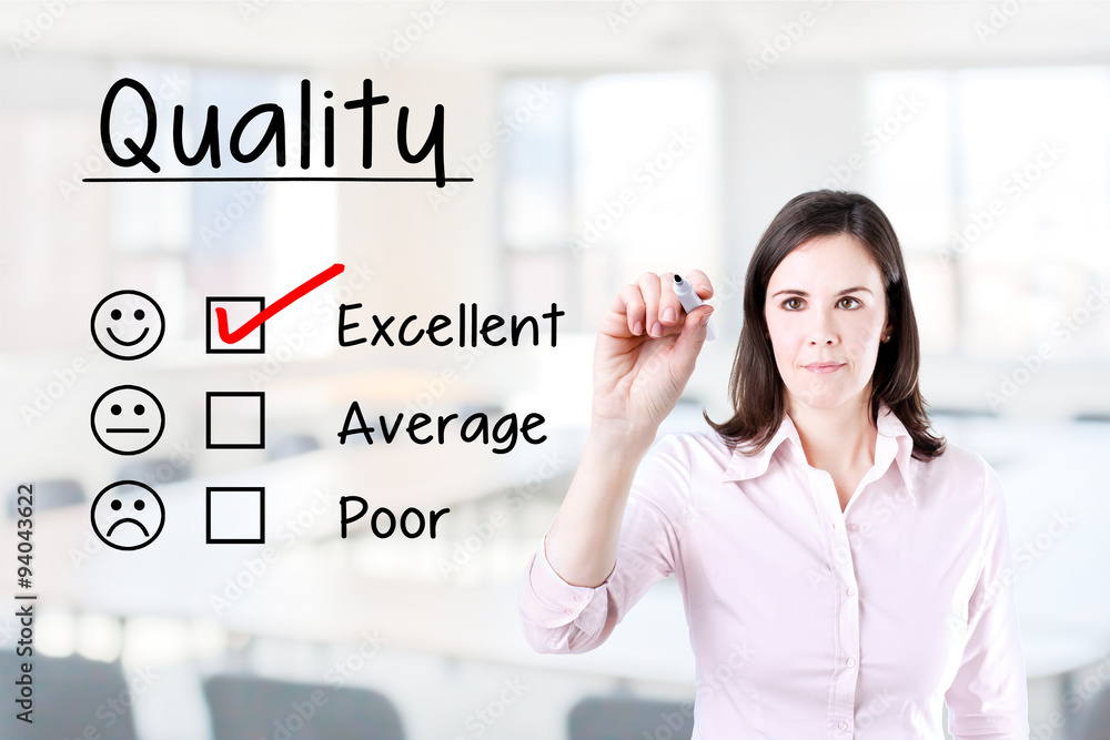 Hand putting check mark with red marker on excellent quality evaluation form. Office background. Hand putting check mark with red marker on excellent quality evaluation form. Office background.