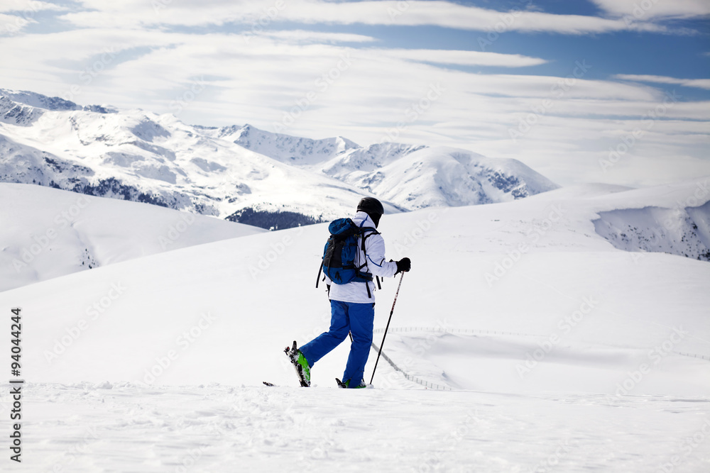 Cross-country skier - snowy mountains in the background Cross-country skier - snowy mountains in the background