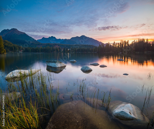 The sunrise over a lake in the park High Tatras. Shtrbske Pleso,