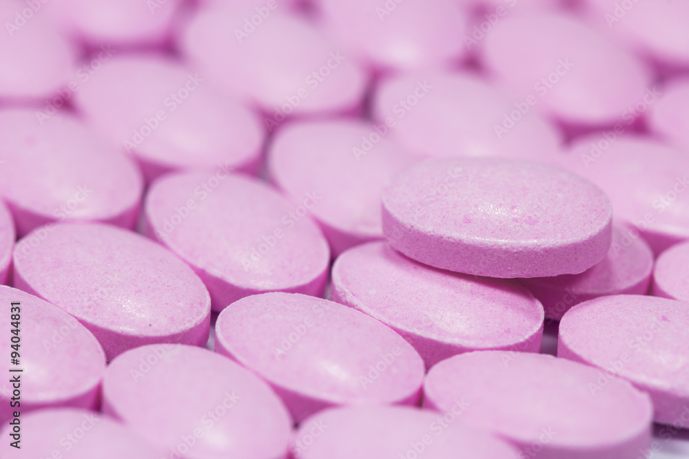 The pink tablets isolated on white background The pink tablets isolated on white background
