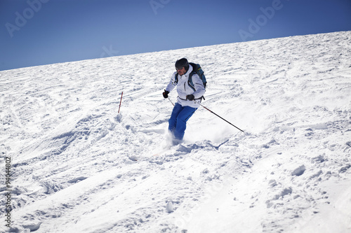 Man skiing on slope - winter holidays