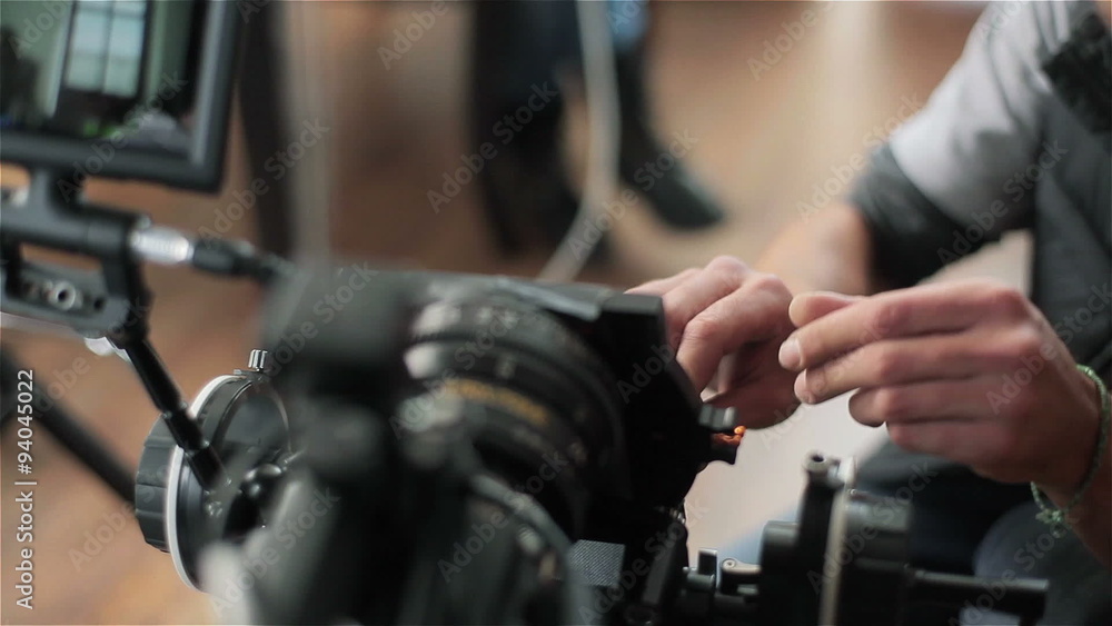 Preparing video camera for shooting. Changing lens of red camera. Close-up Preparing video camera for shooting. Changing lens of red camera. Close-up