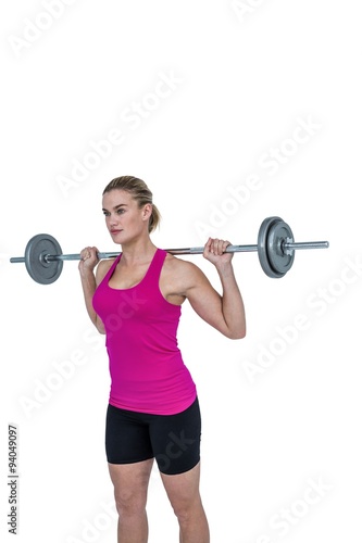 Sporty female bodybuilder lifting barebell 