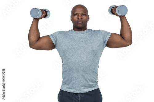 Fit man exercising with dumbbell