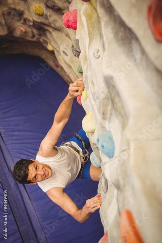 Man climbing up rock wall