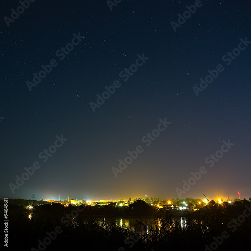 Stars in the night sky on a background city lighting. The bright