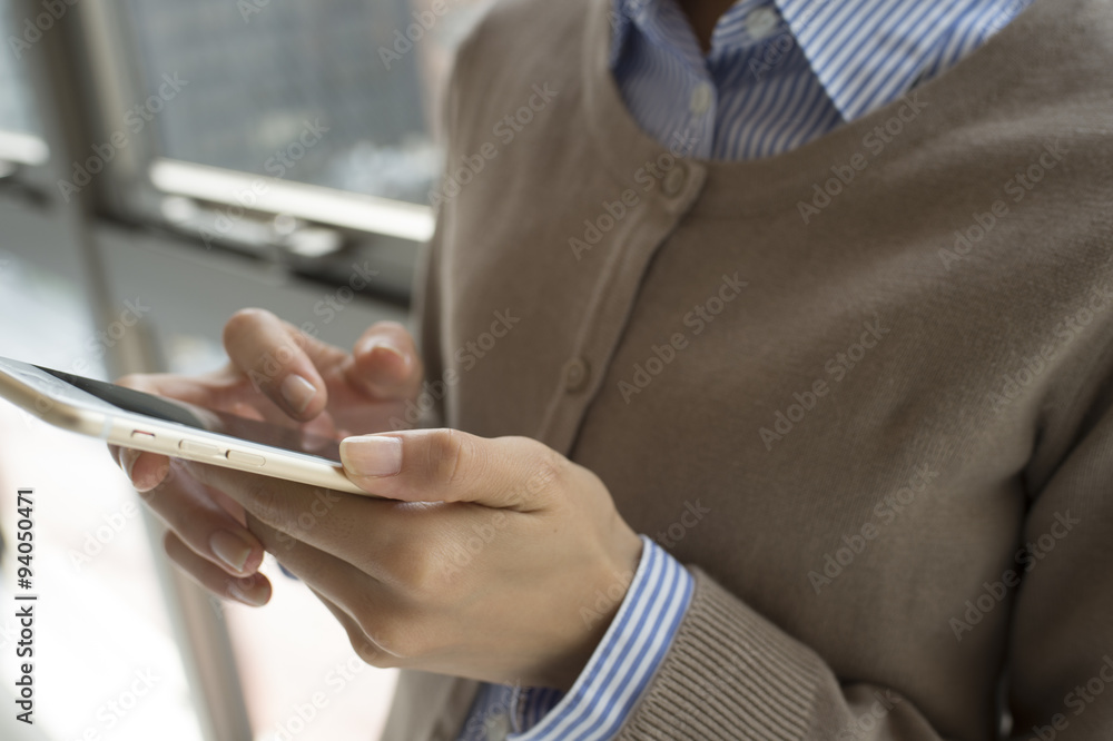 Young women are looking at the smartphone to break time Young women are looking at the smartphone to break time