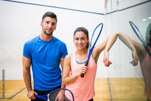 Happy couple about to play squash photo