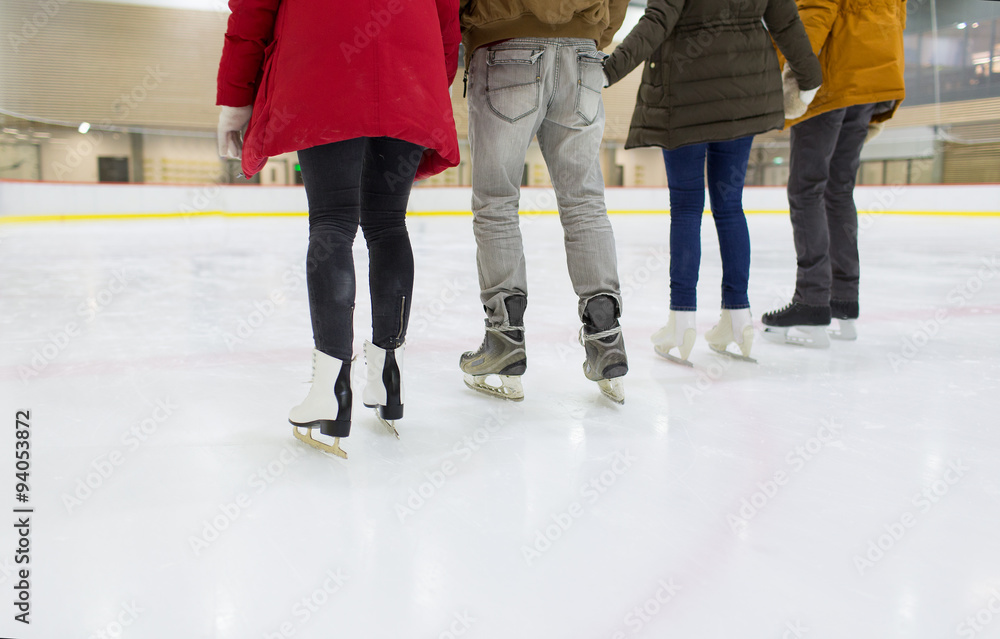 close up of happy friends skating on ice rink close up of happy friends skating on ice rink