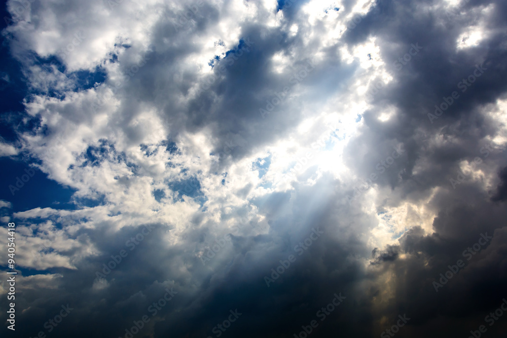 Obraz premium rain cloud and sun beam with dark sky