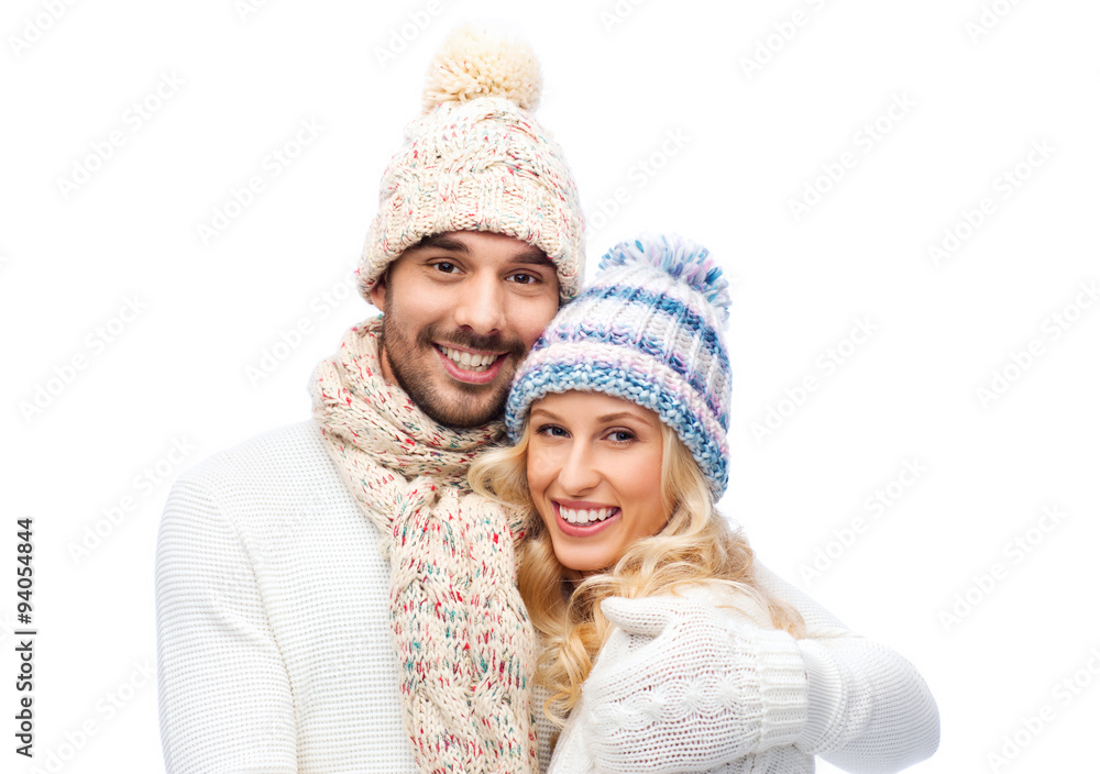 smiling couple in winter clothes hugging smiling couple in winter clothes hugging