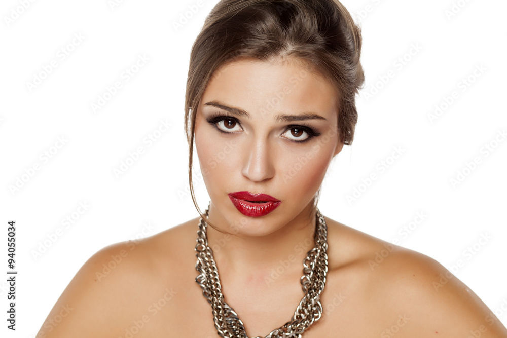 portrait of a young serious beautiful woman with a necklace portrait of a young serious beautiful woman with a necklace