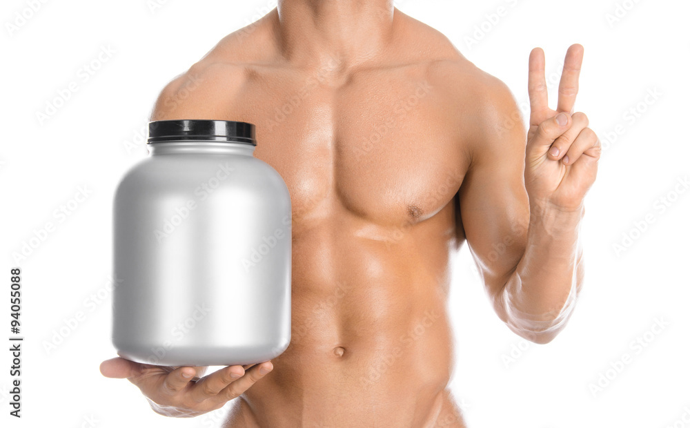 Bodybuilding and Sports theme: handsome strong bodybuilder holding a plastic jar with a dry protein and showing gesture isolated on white background in studio Bodybuilding and Sports theme: handsome strong bodybuilder holding a plastic jar with a dry protein and showing gesture isolated on white background in studio