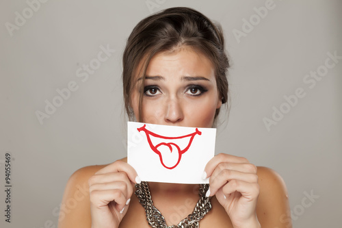 beautiful young woman holding a paper with a smile