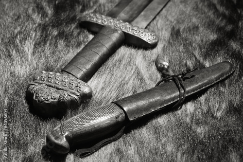 Viking sword and knife on a fur photo