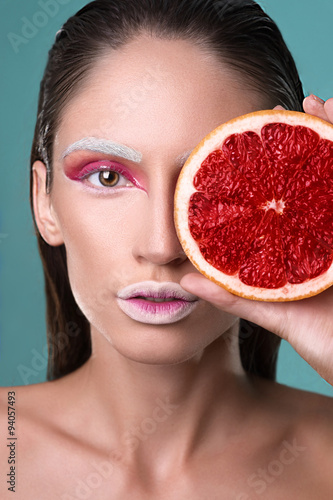 Picture of young beautiful woman with grapefruit