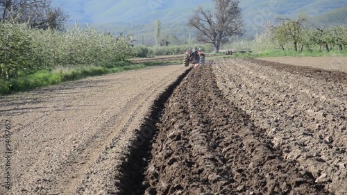 Tractorist plowing field