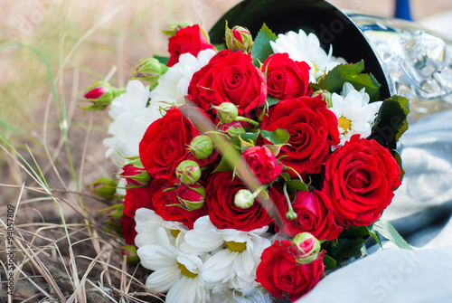 wedding bouquet of red roses in the champagne bucket