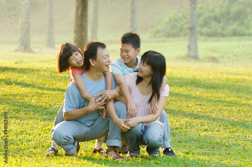 Family lying outdoors being playful and smiling, Outddor portrai