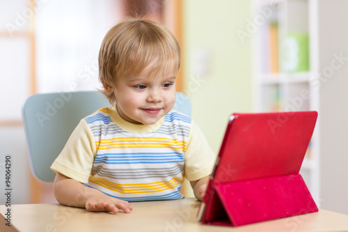 Cute kid toddler boy with tablet pc