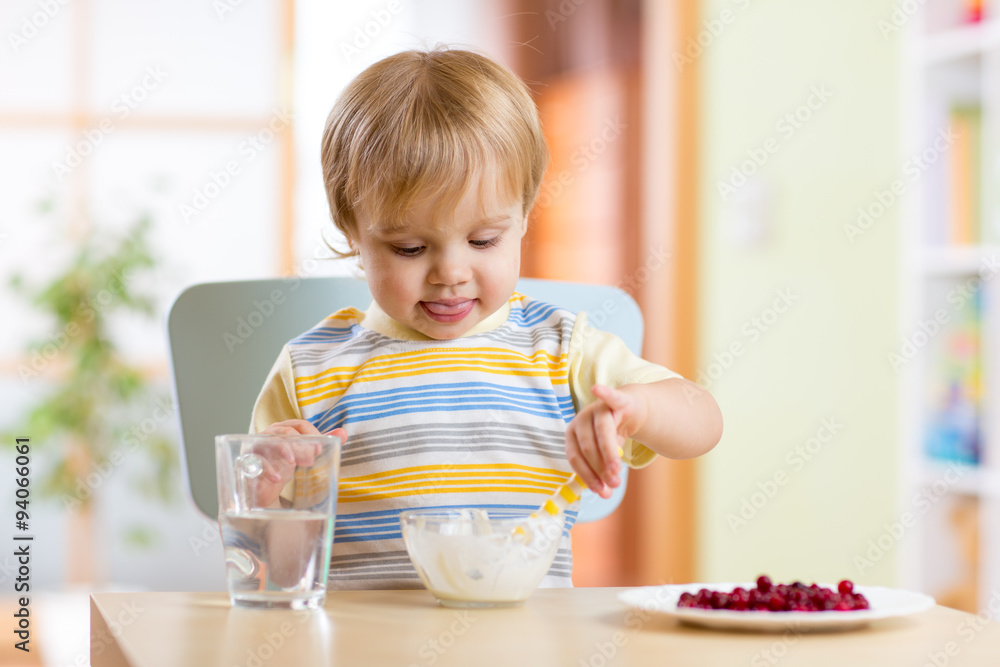 child eating healthy food with a spoon child eating healthy food with a spoon