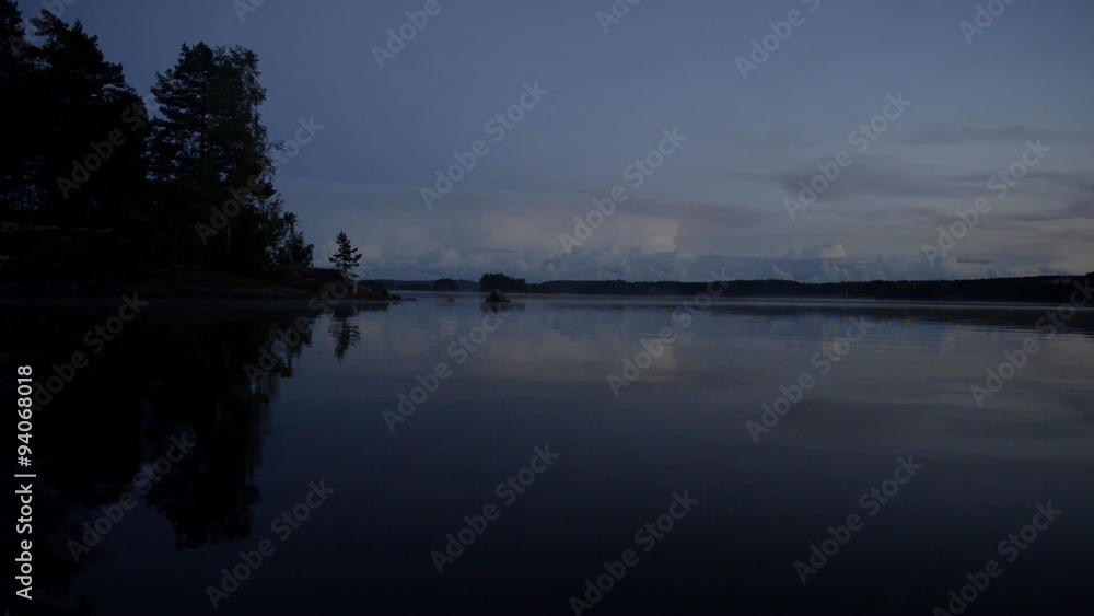 Gentle waves during a sunset over a lake in Sweden during summer. Gentle waves during a sunset over a lake in Sweden during summer.