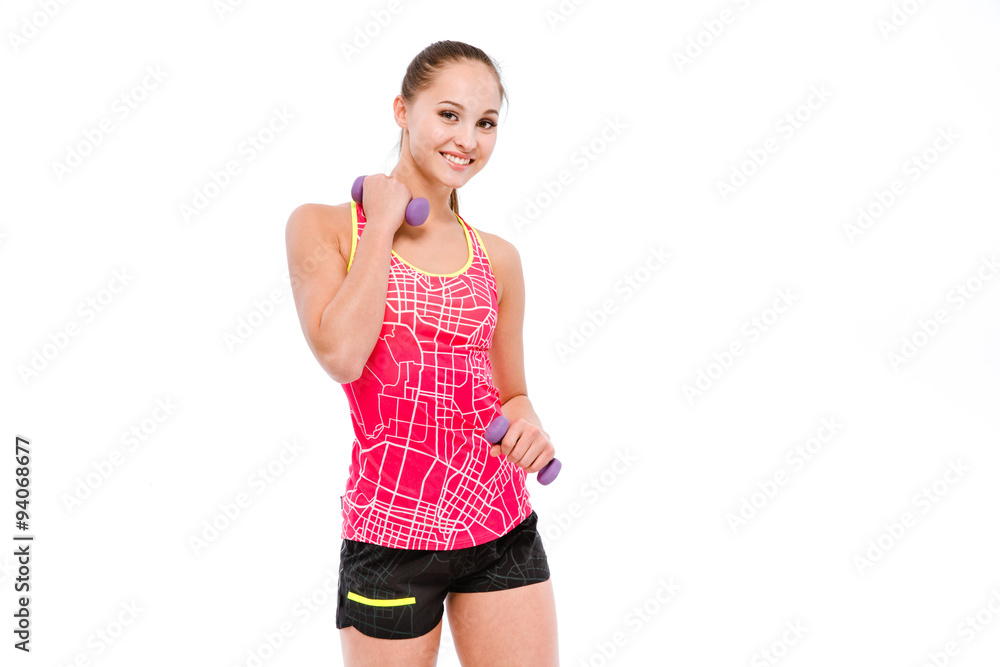 Young sportswoman exercising with dumbbells Young sportswoman exercising with dumbbells