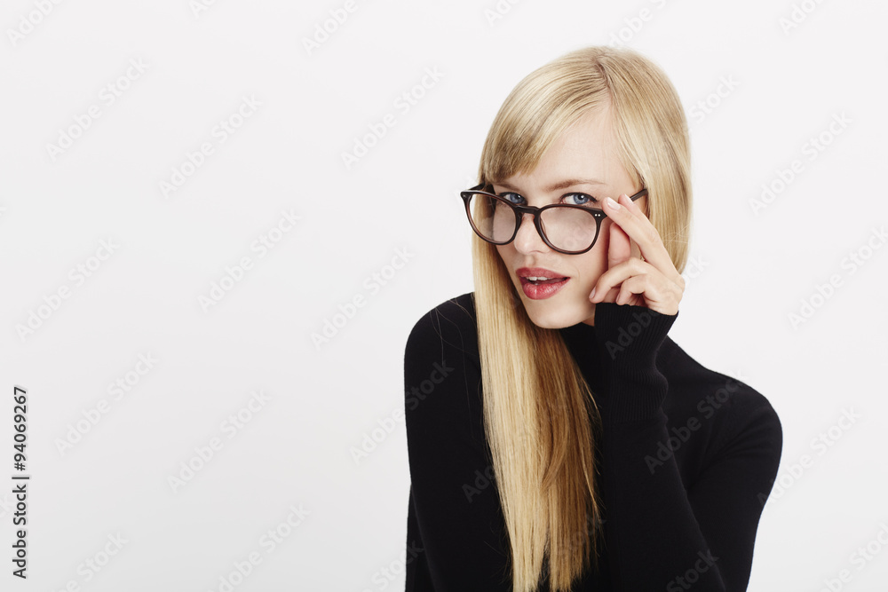 Focused blond woman in spectacles and black