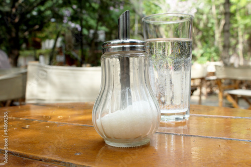 Glass sugar bowl and glass of water  photo