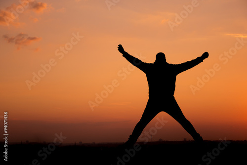 Fototapeta Naklejka Na Ścianę i Meble -  People Silhouette / jumping man in the sunset   