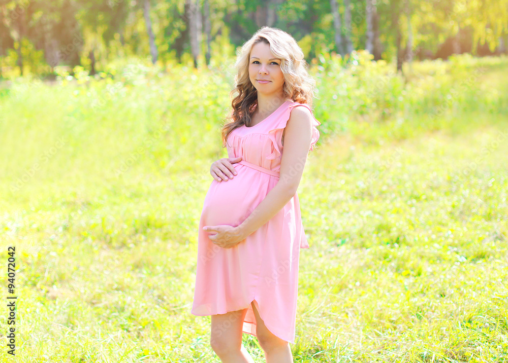 Beautiful young pregnant woman in sunny summer day Beautiful young pregnant woman in sunny summer day