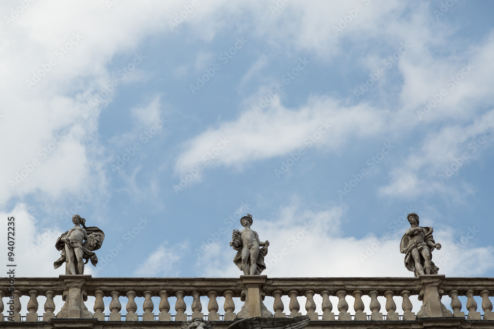 statues adorning the roof of the baroque Palazzo Maffei on the Piazza delle Erbe, Verona, Italy