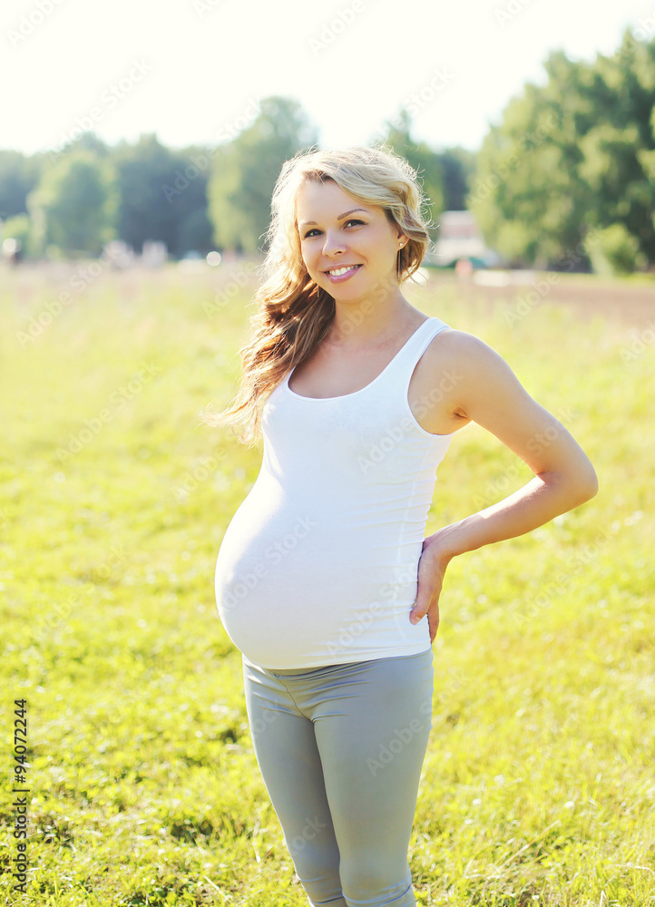Portrait happy smiling pregnant woman outdoors in summer day Portrait happy smiling pregnant woman outdoors in summer day