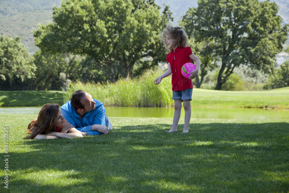 Happy family is enjoying at park on a weekend day Happy family is enjoying at park on a weekend day