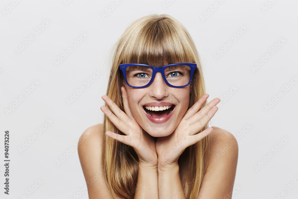 Young blond woman in blue spectacles, portrait Young blond woman in blue spectacles, portrait