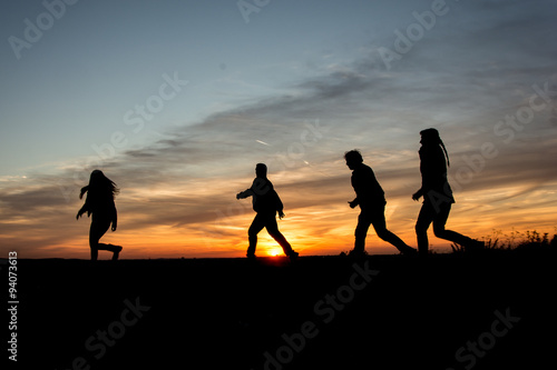 People Silhouette   Family Walking Together Through the sunset