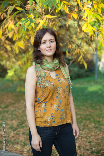 Fototapeta Naklejka Na Ścianę i Meble -  Young woman in yellow autumn park