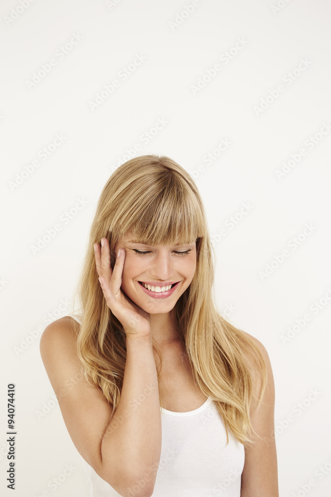 Smiling young woman against white background Smiling young woman against white background
