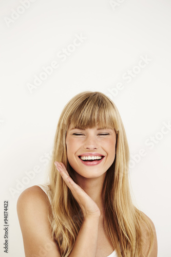 Gorgeous young woman laughing in studio