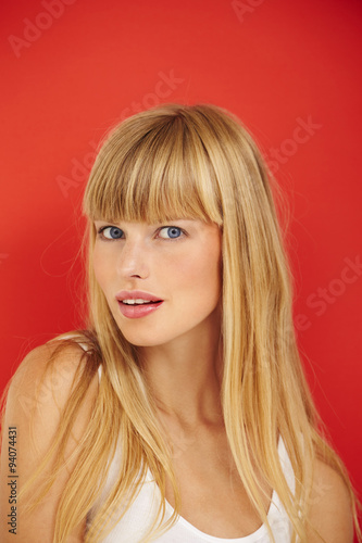Beautiful woman on red background, portrait