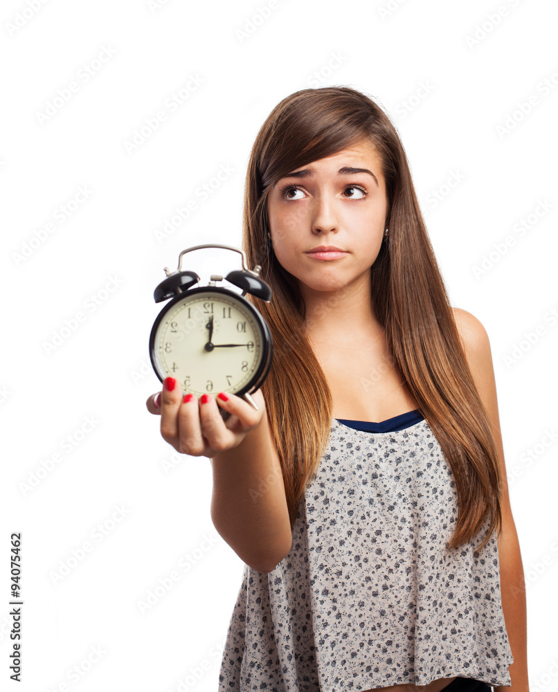 portrait of young woman holding an alarm clock isolated on white