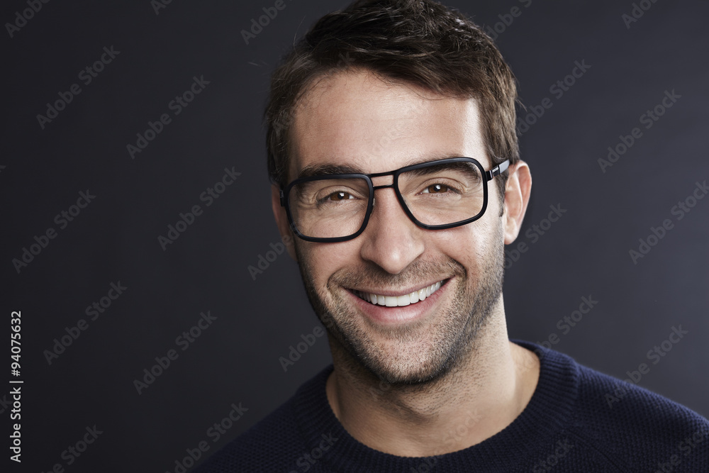 Fototapeta premium Confident man in spectacles smiling at camera