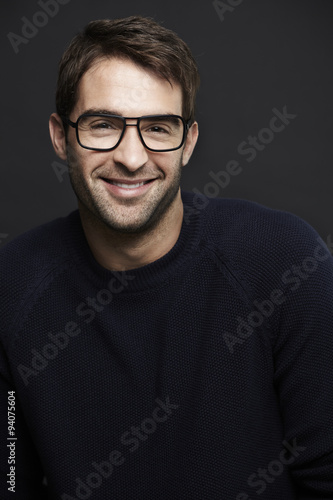 Happy mid adult man in spectacles in studio © sanneberg