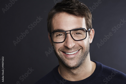 Confident man in spectacles smiling at camera © sanneberg
